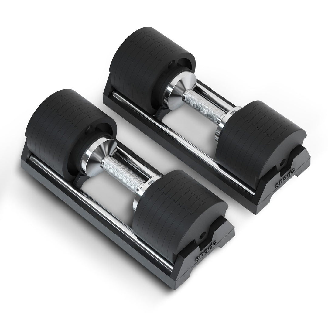 Adjustable cast iron dumbbells set on base with black ribbed plates and chrome bars