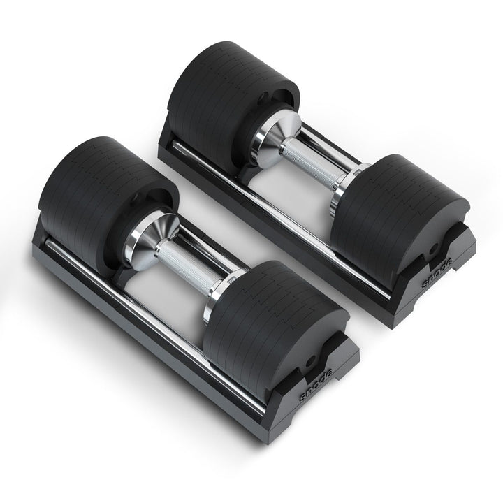 Adjustable cast iron dumbbells set on base with black ribbed plates and chrome bars