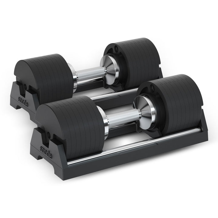 Adjustable cast iron dumbbells on base with black ribbed plates and silver steel handles